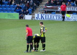 The referee awards Burton a free kick