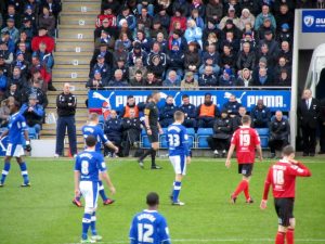 Paul Cook watches on from the touchline