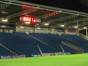 The scoreboard is changed and the nets are put away after the fans have gone home