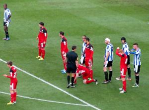 The game is held up while a City player ties his shoelaces