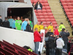 The teams make their way on to the pitch