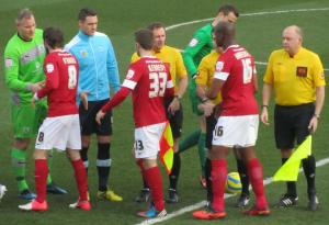 The players and officials shake hands