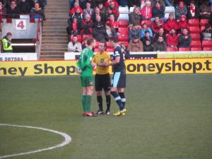 The referee tells the captains to calm their players down