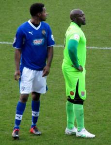 Neal Trotman keeps a close eye on Ade Akinfenwa