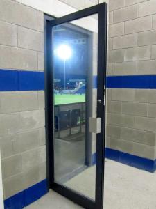 The floodlight shines through a door