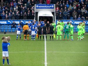 The two teams make their way on to the pitch