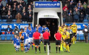 The two teams make their way on to the pitch