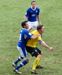 Sam Hird and Barry Corr battle for possession