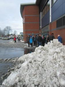 Queues for tickets alongside the large piles of snow