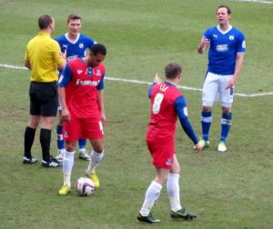 The referee awards a free kick to Gillingham