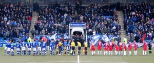 The two teams line up prior to kick off