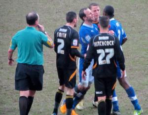 Sam Togwell holds back an angry Nathan Smith