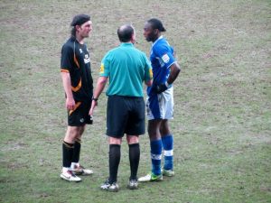 The referee speaks to John-Joe O'Toole and Nathan Smith after the incident
