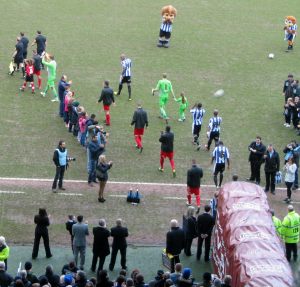 The players make their way on to the pitch