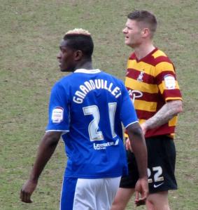 Michael Nelson keeps a close eye on Armand Gnanduillet