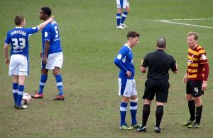 The referee speaks to a couple of players