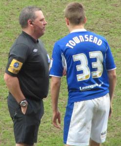 The referee has a chat to Conor Townsend