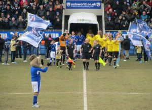 The two teams make their way onto the pitch