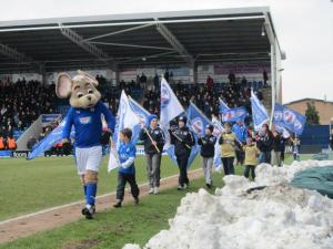Chester and a few young Spireites carry flags around the pitch
