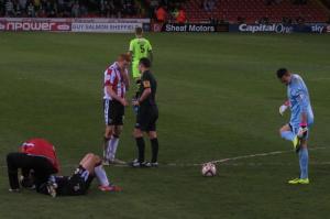 McFadzean receives treatment while Dave Kitson has a word with the referee 