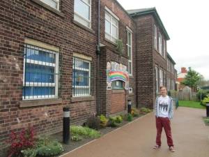 Stood outside the school that John Lennon and George Harrison both attended