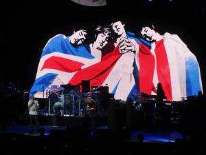 Another screen animation shows the four original members draped in the British flag