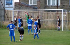 The home side prepare to take a corner