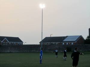 The floodlights shine over the ground