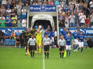 The teams make their way onto the pitch