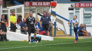 Shaun Beeley takes a throw in for the home side as the two managers look on
