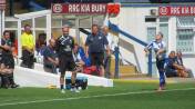 Shaun Beeley takes a throw in for the home side as the two managers look on