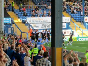 The players and fans celebrate the first goal of the new season