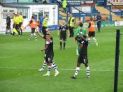 The players applaud and Roberts waves to the fans