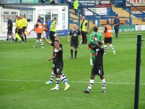 The players applaud and Roberts waves to the fans