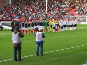 The teams line up on the pitch