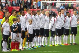 The England players stand for their national anthem