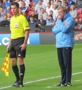 Hodgson stands on the touchline