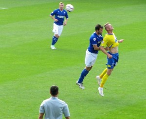 Michael Smith beats Sam Hird to a header