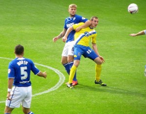 Liam Cooper and Luke Moore battle for the ball