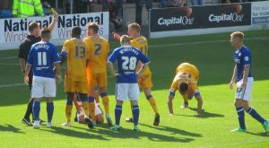 The referee shows a yellow card