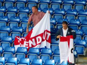 The disappointed Southend fans pack away their flags