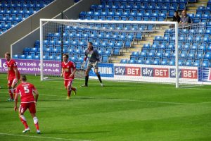 The Accrington keeper screams at his defenders