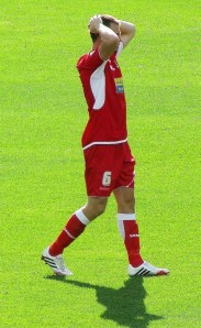 Dean Winnard holds his head in disappointment