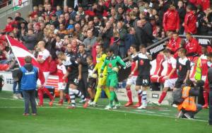 The two teams make their way onto the pitch