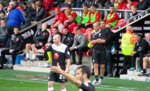 Paul Cook looks on from the touchline