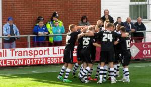 The players celebrate the opening goal