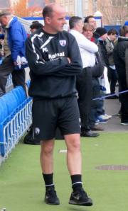 Paul Cook watches the warm ups