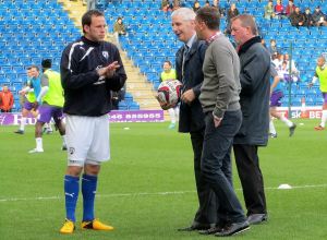 Sam Togwell takes part in a presentation on the pitch