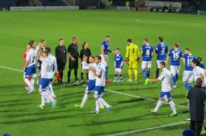 The teams make their way on to the pitch