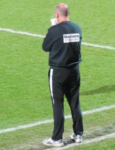 Paul Cook looks on from the touchline